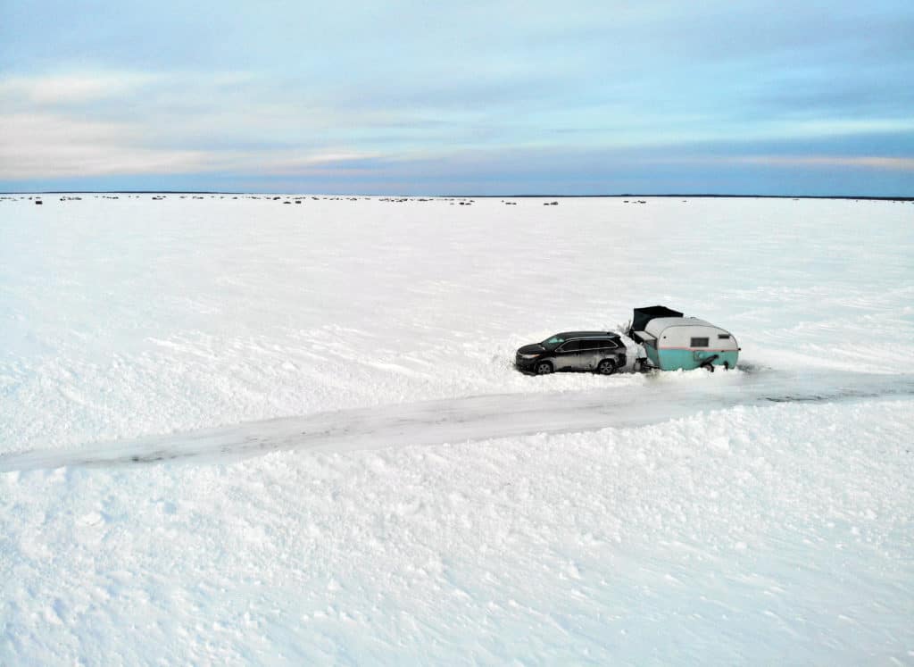 Aerial view of fish house camper on Lake of the Woods ice road.