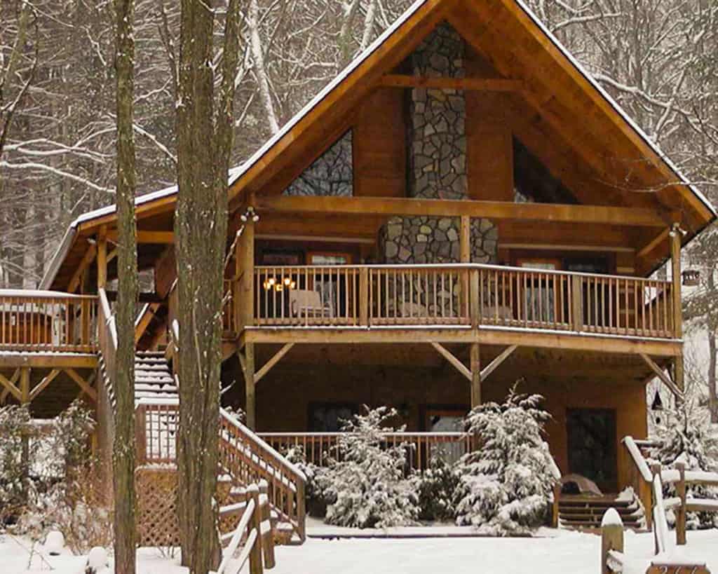 Scenic snow covered log-cabin retreat in the wooded mountains of Boone, North Carolina 