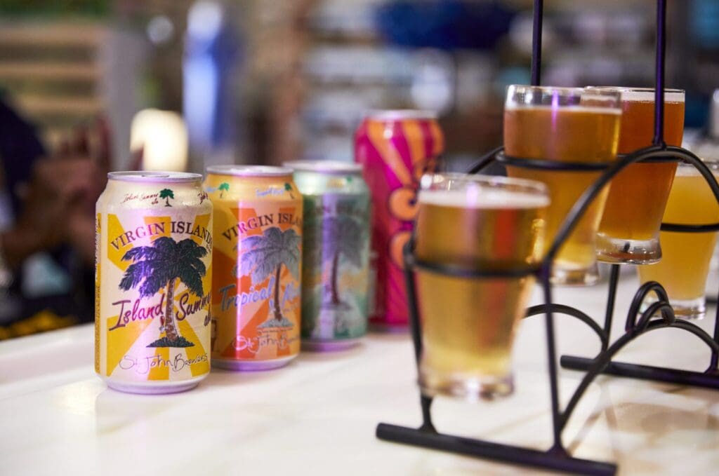Cans of beer and glasses of frothy brews from St. John Brewers.|