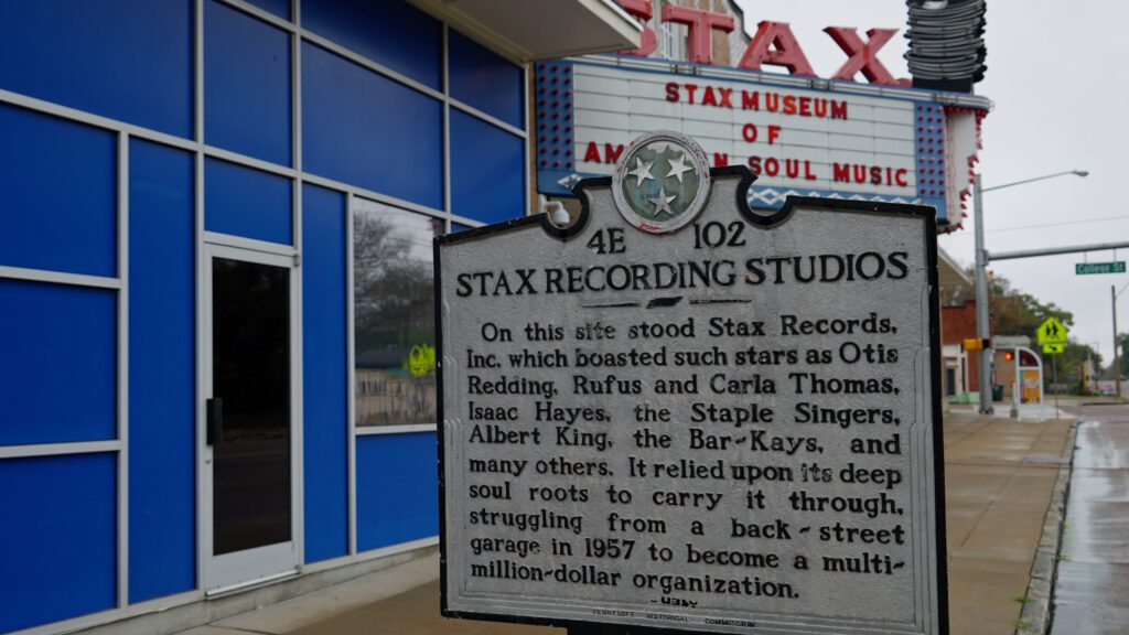 Historical marker outside Stax Museum of American Soul Music. The plaque details the history of Stax Recording Studios and mentions famous artists like Otis Redding. The building and surrounding sidewalk are visible in the background.