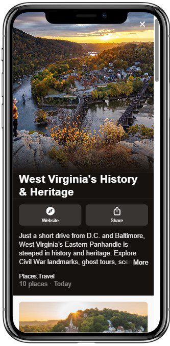 A phone screen displays a travel app featuring a scenic view of a river, railroad bridge, and a small historic town at sunset, promoting West Virginias history and heritage with visiting information.