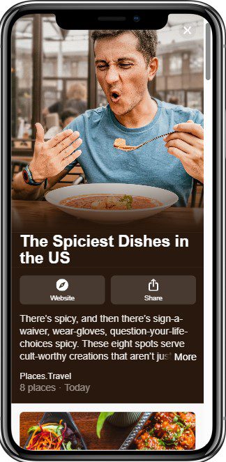 A man grimaces as he eats a spicy dish in a restaurant. The article title on his phone reads, The Spiciest Dishes in the US, and a description mentions eight extremely spicy food spots.