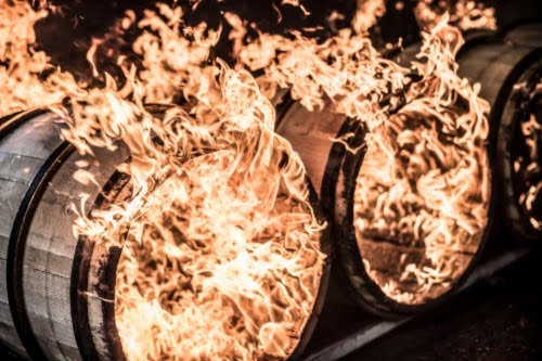 Wooden barrels with flames erupting from their open ends.